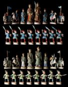 A late 19th century Chinese polychrome ivory Mandarin pattern chess set: one side on red painted