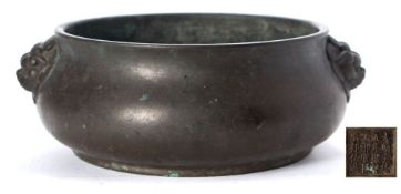 A Chinese bronze censer: of compressed globular form with mythical beast mask handles,
