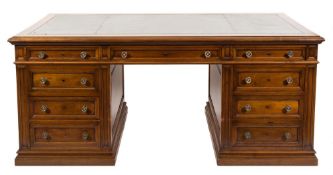 An Edwardian walnut pedestal desk:, of large size, the top with a moulded edge,
