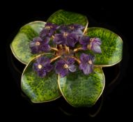 A green enamelled and carved amethyst 'violet' spray brooch: with carved amethyst 'violet' flower