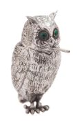 A Continental silver cigarette holder in the form of an owl: smoking a cigarette,