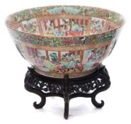 A large Canton famille rose bowl: painted with panels of interior and terrace scenes with officials,