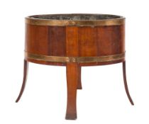 A 19th Century teak and brass bound oval jardiniere or wine cooler: having a twin-handled metal