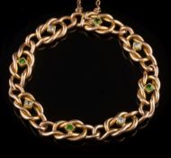 An early 20th century gold, diamond and demantoid garnet eight-stone,
