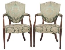 A set of four early 19th Century mahogany open armchairs:, in the Hepplewhite taste,
