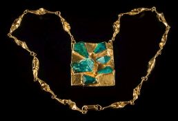 A mottled green hardstone mounted panel pendant: the freeform rectangular panel 63mm x 52mm