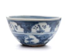 A miniature Chinese porcelain bowl: the exterior painted in blue with two bands containing small