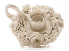 A rare First Period Belleek boudoir candlestick: of florally encrusted form with rustic handle,
