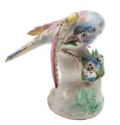 A Bow model of a bunting: with pink, yellow and blue plumage, it's head under one wing,