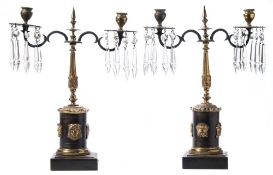 A pair of Regency period ormolu and lustre twin branch lights: the urn-shape nozzles with lobed