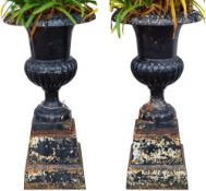 A pair of cast metal campana shaped garden urns: with half reeded decoration,