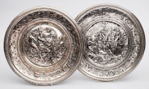Two Elkington electrotype chargers: the centres embossed with neo-classical scenes,