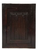 A 17th Century oak wall cupboard:, enclosed by a linen fold panel door,