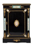 A 19th Century French ebonised and gilt metal and porcelain mounted pier cabinet:,