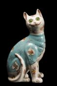A Galle-style pottery cat: modelled seated and transfer decorated with flowers on a pale blue