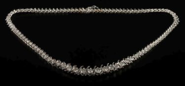 A graduated diamond tennis necklace: of 'S' link design with circular,