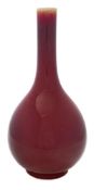 A Chinese 'sang-de-boeuf' bottle vase: covered with a copper-red glaze thinning at the neck,