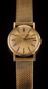 Gubelin. A lady's 18ct gold cased wristwatch: on a 9ct gold bracelet, 35gms gross weight.