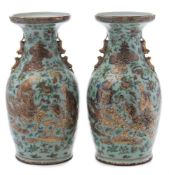 A pair of Canton famille rose baluster vases: with double lion dog handles,