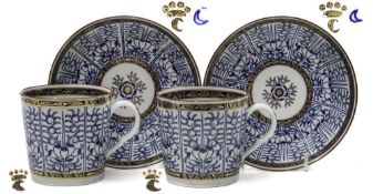 A pair of Worcester porcelain coffee cans and deep saucers: painted in blue in the 'Royal Lily'