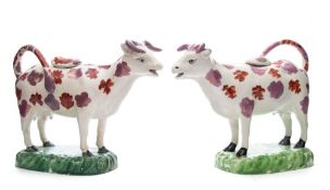 A pair of Welsh pearlware cow creamers: each modelled standing four square and decorated with