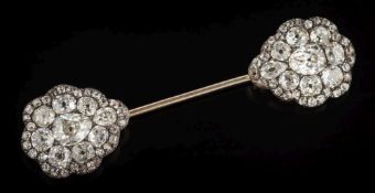 A diamond mounted jabot pin: with two pear-shaped clusters,