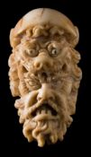 A 19th century Continental carved ivory cane handle: with lion mask and grotesque mask decoration,