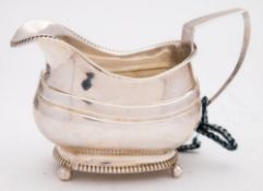 A George III provincial silver cream jug, maker George Ferris, Exeter 1815: crested,