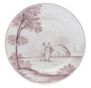 A Bristol delftware plate: painted in manganese with a lady and gentleman standing in an extensive