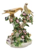 A Bow 'Birds In Branches' candlestick group: modelled as two birds perched on flowering branches,