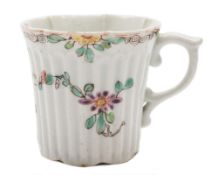 An early Worcester ribbed coffee can: of lobed form with pleated rim and scroll handle,