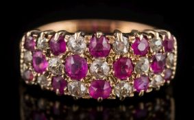 A ruby and diamond cluster ring: with graduated oval and round rubies between round old-cut