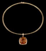 An amber coloured cushion-shaped, single-stone pendant: the reverse stamped 'Halberstadt 585',