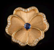 A sapphire and diamond mounted pansy brooch: the single flower head with central round sapphire 6.