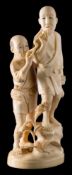 A Japanese carved ivory okimono: of two peasants smoking pipes, in traditional costume,