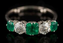 An emerald and diamond five-stone ring: with three 'emerald-cut' emeralds approximately 4.2mm, 5.