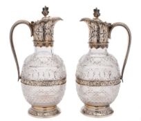A pair of Victorian clear glass and silver mounted claret jugs, maker Horace Woodward & Co Ltd,