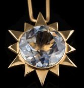 A circular sapphire mounted star-burst pendant:, the pale blue sapphire approximately 19mm diameter,