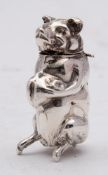 A white metal novelty vesta case: unmarked, in the form of a pig, with hinged head and strike pad,