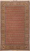 An Isfahan rug:, the brick red field with a repeated design of urns of flowers,