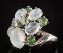 A moonstone and demantoid garnet cluster ring: with five oval moonstones,