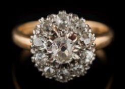 A diamond mounted oval cluster ring: the central, oval-cut diamond approximately 0.
