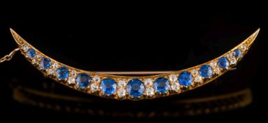A 19th century gold, sapphire and diamond crescent brooch: with round sapphires graduated from 2.