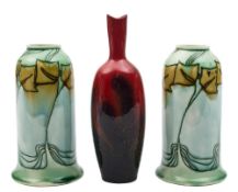 A pair of Minton Secessionist vases and a Royal Doulton flambé veined vase: the former of