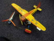 Mettoy K2010 tinplate clockwork aircraft G-A AG1 :, in red and yellow,