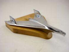 A 1957 Chevrolet chrome plated car mascot:, on later wooden base 35cm long.