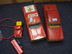 A battery operated tinplate sedan, together with a friction drive 'Fire Chief Car':,