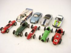 A group of nine white metal sports cars:, including a two Porsche 911's ,