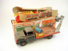 Marx Toys (USA) a tinplate clockwork 'Sparking Mechanical Tractor and Trailer':, in original box,