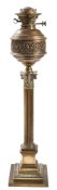 A late Victorian brass oil lamp: the circular reservoir with banded foliate decoration,